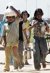 SWEET BURDEN: As schools re-open after break, students take home mid-day meals in Chandigarh