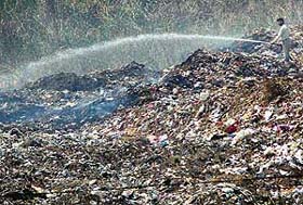 Fire brigade personnel try to put out the fire at a garbage dump in Phase VIII, Industrial Area, Mohali