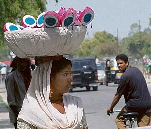 Even in this electronic age, there are some who earn their livelihood by making traditional hand-made toys like this woman in Mohali.