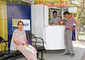A commuter buys eatables from a kiosk at the bus shelter opposite the GMCH, Sector 32, in Chandigarh on Wednesday.