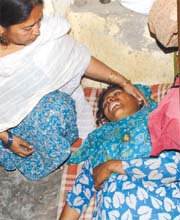 A woman who lost two children in a fire at a slum near Zakir Nagar being consoled by relatives