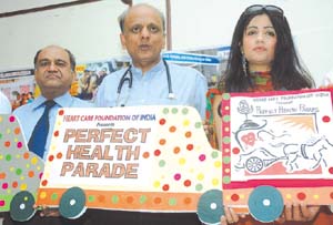 President of Heart Care Foundation of India Dr K. K. Aggrawal is flanked by noted singer Shibani Kashyap and Prof N. P. Gupta from AIIMS as he announces holding of Perfect Health Mela on April 9