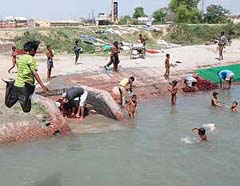 Children enjoy in a river in Panipat on Wednesday to cool off as mercury continues to soar.