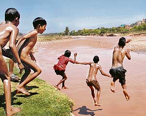 Children swimming in the Ghaghar near Nadha Sahib Gurdwara in Panchkula.