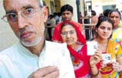 A family showing their Voter I-cards before casting their franchise for the Municipal Corporation of Delhi elections in the Capital on Thursday