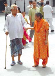 An old woman helping her husband to reach a polling booth in the Capital on Thursday