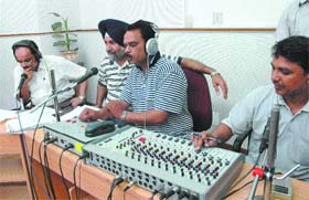 AT WORK: Anchors of All India Radio, broadcasting live commentary of the World Cup in the studio of FM Rainbow, Jalandhar