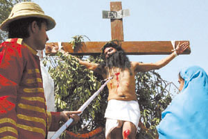 An unidentified man plays the role of a crucified Jesus Christ on Good Friday at a function in the church at Kingsway Camp.