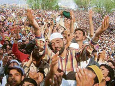 Kashmiri Muslims look at a relic of Prophet Mohammad being displayed during Id-e-Milad at the Hazratbal shrine in Srinagar.