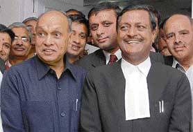 Former Chief Minister P.K. Dhumal with lawyer Satpal Jain at the district courts in Shimla on Saturday where hearing in a corruption case is in progress.