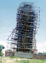 a Gurdev Singh, an office-bearer of the Shaheed Kartar Singh Sarabha Memorial Committee, points out at the under-construction memorial of Shaheed Kartar Singh Sarabha at his native village near Ahmedgarh