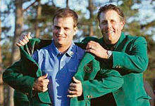 Zach Johnson (left) receives the traditional green blazer from last years champion Phil Mickelson after winning the US Masters golf tournament at the Augusta National Golf Club in Georgia.