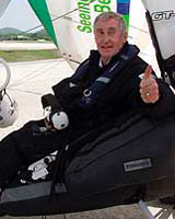Pilot Miles Barber of Britain gives a thumbs-up before departing the Phuket airport for Malaysia in micro light aircraft on Monday.