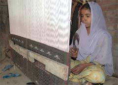 HOPE FLOATS: A border village girl weaves carpet at her house. 