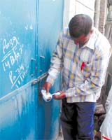 An MCD employee sealing a factory at Krishna Nagar in East Delhi on Wednesday