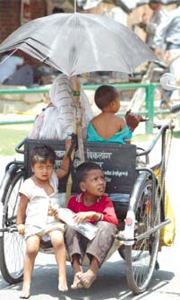 Kids taking a ride with their physically challenged mother aboard her hand-propelled vehicle even as the mercury continued to soar in the Capital.