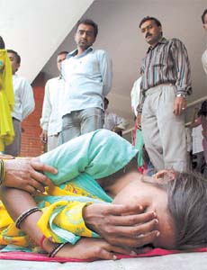 A fainted girl lies unattended outside the Emergency Ward of LNJP Hospital even as the resident doctors strike entered its second day today
