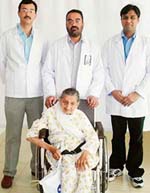 Patient Tara Devi on a wheelchair with Dr Harpreet S. Gill (centre), Dr Gaurav (left) and Dr Neeraj (right)