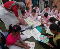Health minister Laxmi Kanta Chawla (R) takes a look at one of the artworks.