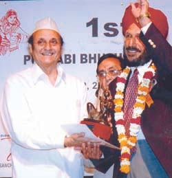 President of ICCR Dr Karan Singh presenting Punjabi Bhushan Award to Flying Sikh Milkha Singh at a function oraganised by Punjabi Kala Sangam in the Capital on Friday