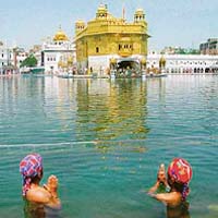 Children take a dip in the sarovar at the Golden Temple, Amritsar