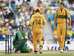 Australian captain Ricky Ponting runs in to check on Irelands Andrew White, who was hit on the head off the bowling of Glenn McGrath (right) during the Super Eight match at the Kensington Oval in Bridgetown on Friday. 