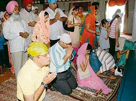 Devotees pay obeisance on the occasion of Baisakhi at Shri Nada Sahib Gurdwara in Panchkula on Saturday.