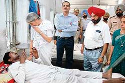 Laxmi Kanta Chawla, health minister, Punjab, enquires about the health of a prisoner at the hospital in Amritsar Central Jail