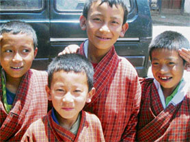 Schoolchildren, like all Bhutanese, are attired in the national dress.