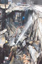 Firefighters trying to douse fire at Sadar Bazar in the Capital on Sunday