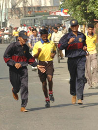 Army personnel seen running along with their participant during the Jalandhar Marathon Rally.