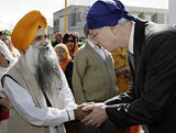 Stephane Dion (right) greets a member of the Gurdwara Sahib Sikh gurdwara in Vancouver.