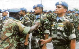 Col Moumouni Zankaro pins UN medals on the chests of 2 Raj Rif personnel in Katanga.