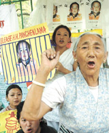 Tibetan demonstrators display posters of Panchen Lama demanding his release by the Chinese authorities at Jantar Mantar in the Capital