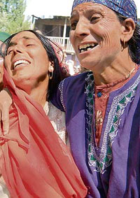Relatives wail over the death of Farooq Ahmad Wani, a civilian killed in crossfire between militants and security forces, at Kakapora in Pulwama district, 35 km from Srinagar, on Monday.