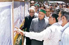 Chief Minister Virbhadra Singh interacts with engineers after laying the foundation stone for a double-lane Auckland tunnel project in Shimla on Tuesday