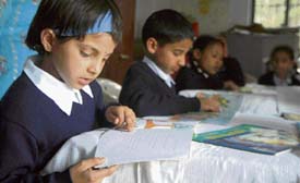 Children read books at one of the libraries set up under the project