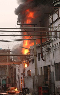 Thick smoke and flames emanate from the factory in Jalandhar on Tuesday.