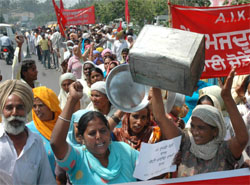 Members of the Pendu Mazdoor Union protest against the governments delay in launching cheap atta-dal scheme, in Jalandhar on Tuesday.