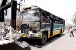 Delhi Traffic Police van removing the private bus burnt by an angry crowd after it ran over a child at Angad Nagar in East Delhi
