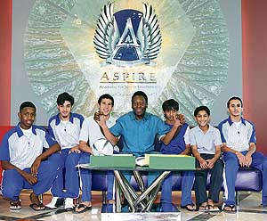 Brazilian football legend Pele poses with students after a press conference at the Aspire Academy of Sports Excellence in Doha on Wednesday. The Qatari sports academy has launched a programme that will provide African students from seven nations with a chance to study and train in one of the worlds most advanced sports academies. 