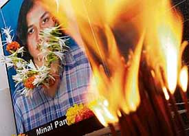 The portrait of Minal Panchail, who was killed in the Virgina Tech University shootout, is seen through burning incense sticks at a memorial service in Rizvi College in Mumbai on Thursday. Minal completed her degree in architecture from the Rizvi College of Architecture before leaving for Virginia in 2006. 