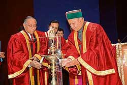 Himachal Governor V.S. Kokje (left) and Chief Minister Virbhadra Singh light a lamp before the start of the first convocation of Jaypee IT University at Vaknaghat on Friday.
