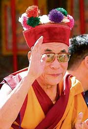 His Holiness the Dalai Lama waves to Tibetan people as he reaches Solan on his way to Rajgarh on Friday. 