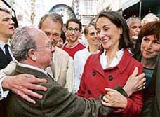 Frances Socialist Party presidential candidate Segolene Royal (R) greets a supporter as she visits the Montorgueil street market in Paris on Friday. Frances presidential candidates began their last day of campaigning on Friday before Sundays first round ballot, making a final push for support in the vote.