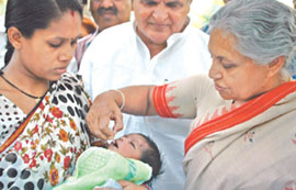 Delhi Chief Minister Sheila Dikshit administering pulse polio drops to a child at her residence on Saturday.