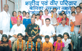 Member of Parliament from Rohtak, Deepender Singh Hooda, Lt. General Satyevir Yadav, former Union Minister Col Rao Ram Singh and Col Ranbir Singh Yadav pose with 21 girls belonging to martyrs families of Rezangla Battle based in Haryana who were honoured by Rezangla Shaurya Samiti at a function held in New Delhi on Saturday.