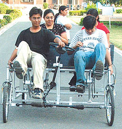 Students of IIT Delhi demonstrating the use of Quadv, a new model rickshaw, developed by a student, during an annual exhibition in the Capital on Saturday.
