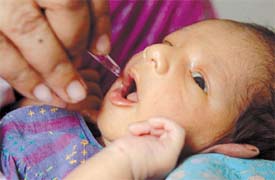 A 13-day-old child getting polio drops in the Capital on Sunday