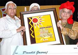 Governor A.R. Kidwai honours vocalist Pandit Jasraj at a function in Karnal on Sunday.
